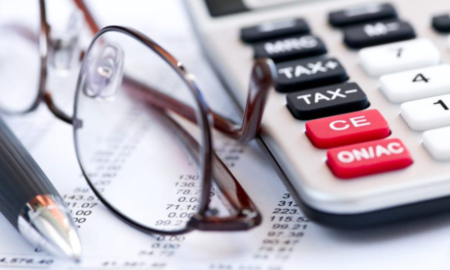 Tax calculator pen and glasses